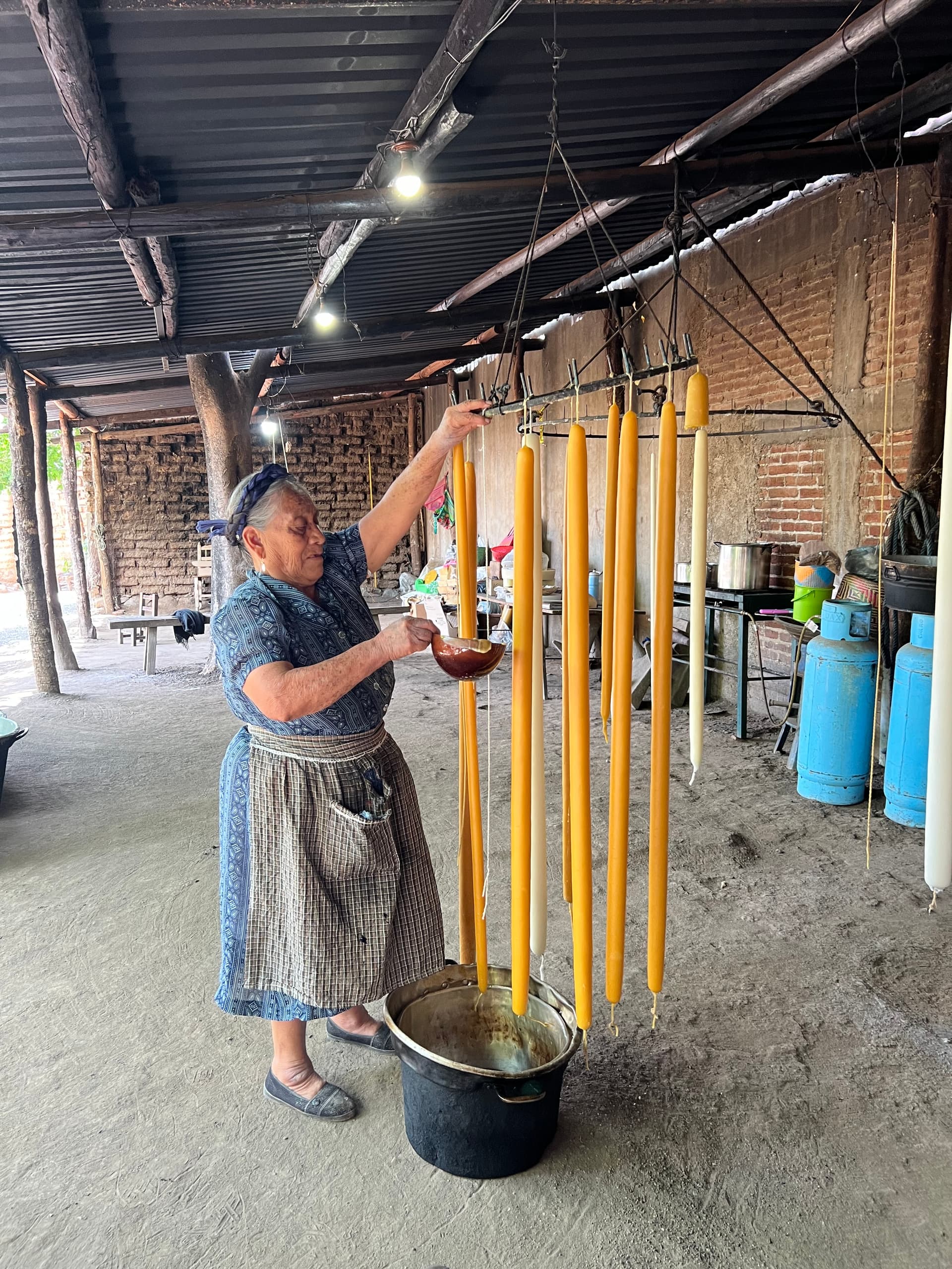 Doña Viviana hand-dipping ceremonial beeswax candles